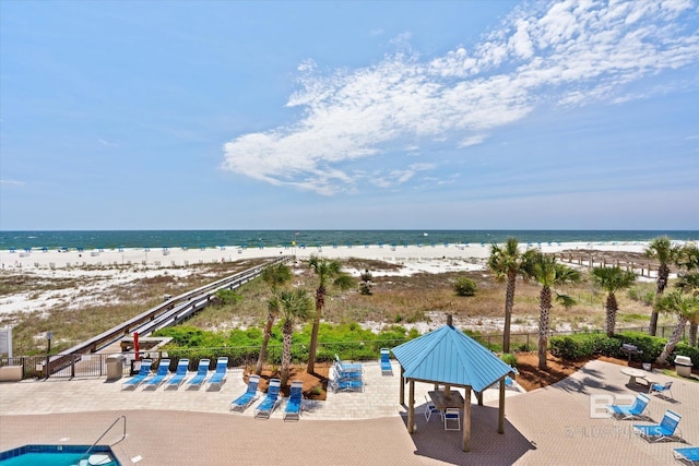 drone / aerial view featuring a water view and a beach view