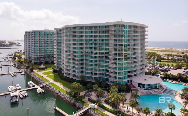 view of property with a water view and a community pool