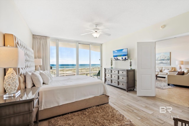 bedroom featuring light hardwood / wood-style floors, access to outside, and ceiling fan