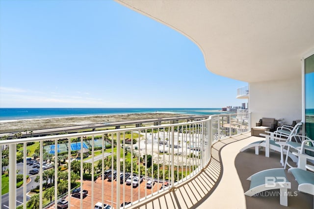 balcony with a water view and a beach view