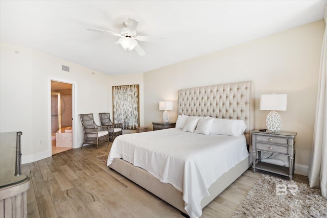 bedroom with hardwood / wood-style flooring, connected bathroom, and ceiling fan