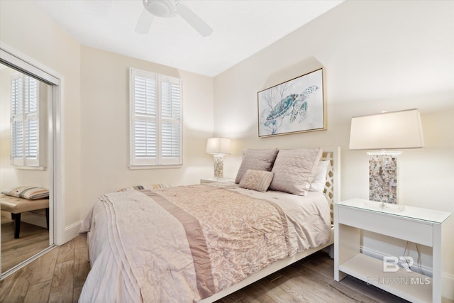 bedroom with ceiling fan, multiple windows, and hardwood / wood-style floors