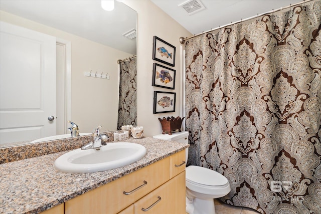 bathroom featuring vanity, a shower with curtain, toilet, and tile patterned floors