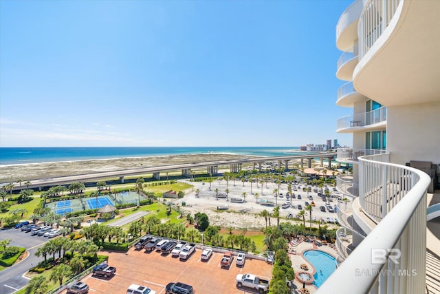 birds eye view of property with a water view and a beach view