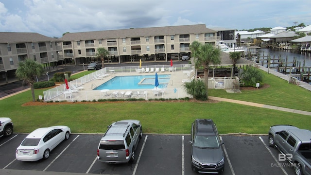 view of swimming pool featuring a lawn