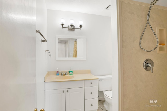 bathroom featuring vanity, toilet, and tile patterned flooring