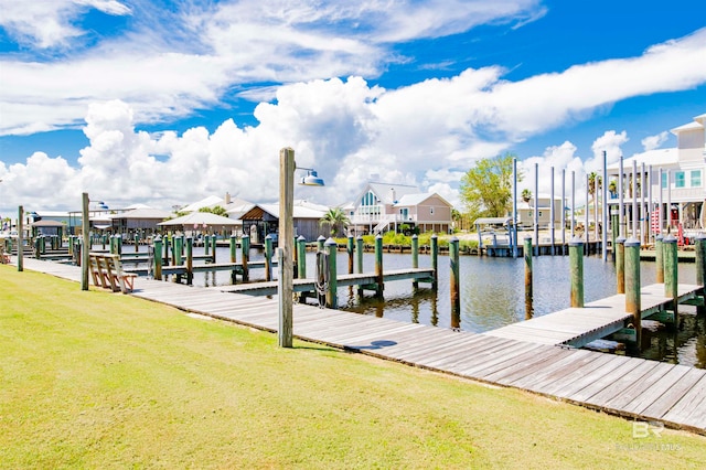 dock area with a lawn and a water view