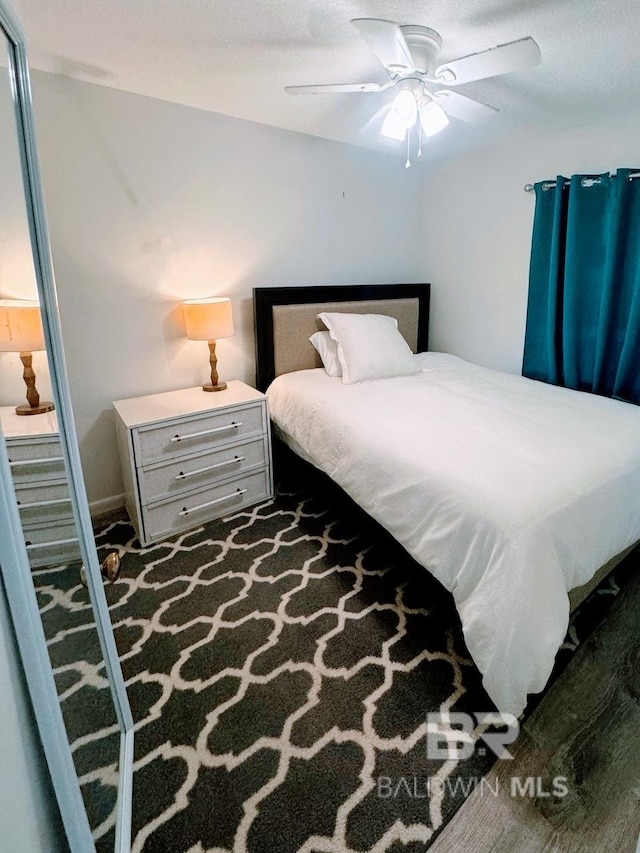 bedroom with ceiling fan and carpet