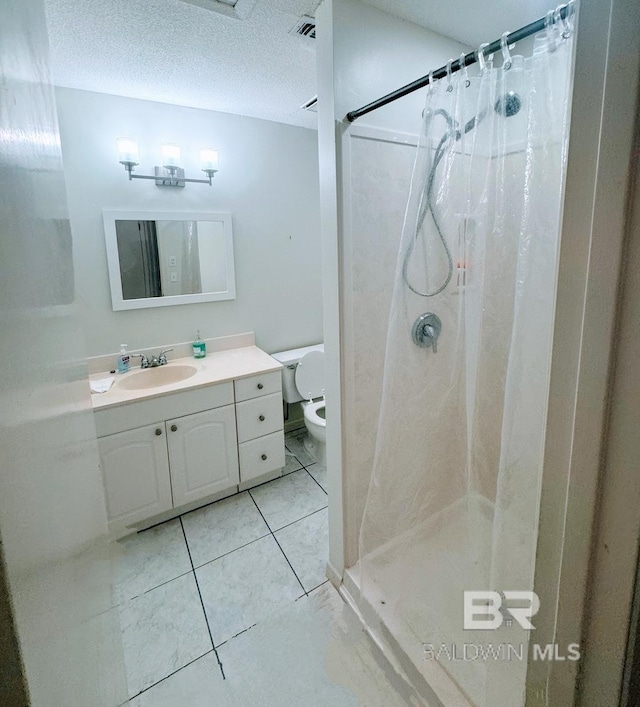 bathroom with tile patterned floors, a shower with curtain, toilet, and vanity