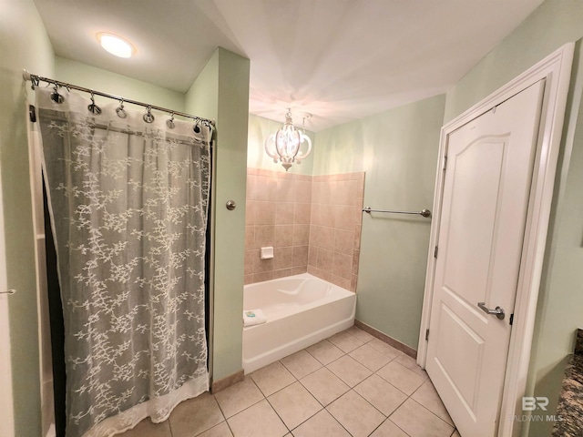 bathroom with tile patterned floors, shower / tub combo with curtain, and a notable chandelier