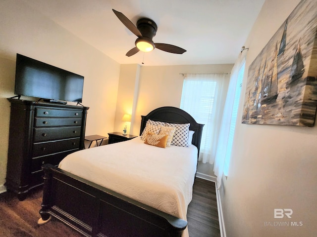 bedroom featuring ceiling fan and dark wood-type flooring