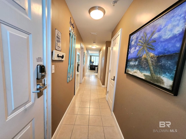 hall featuring light tile patterned floors