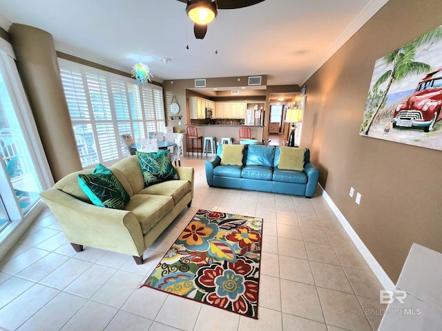 tiled living room with ceiling fan and ornamental molding