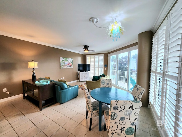 tiled dining space with ceiling fan and ornamental molding