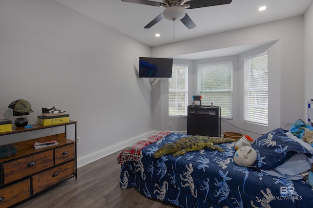 bedroom with dark hardwood / wood-style flooring and ceiling fan