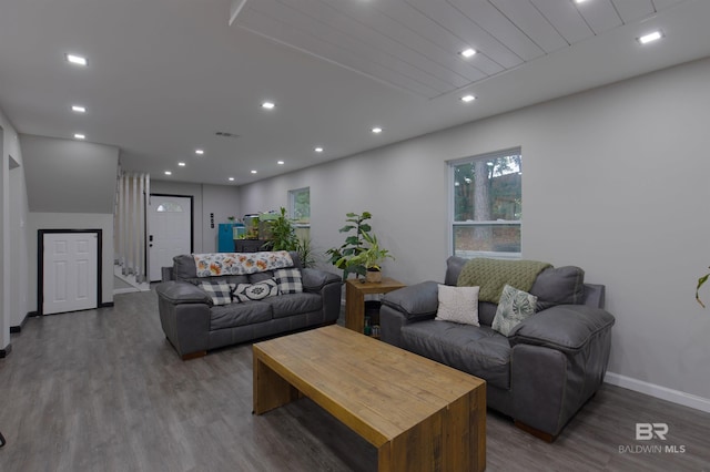living room with baseboards, wood finished floors, visible vents, and recessed lighting