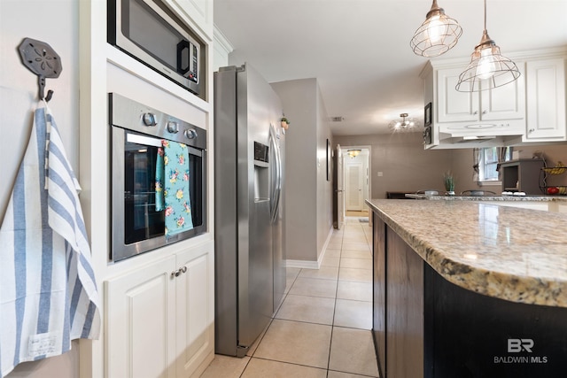 kitchen with light tile patterned flooring, white cabinetry, stainless steel appliances, light stone countertops, and pendant lighting