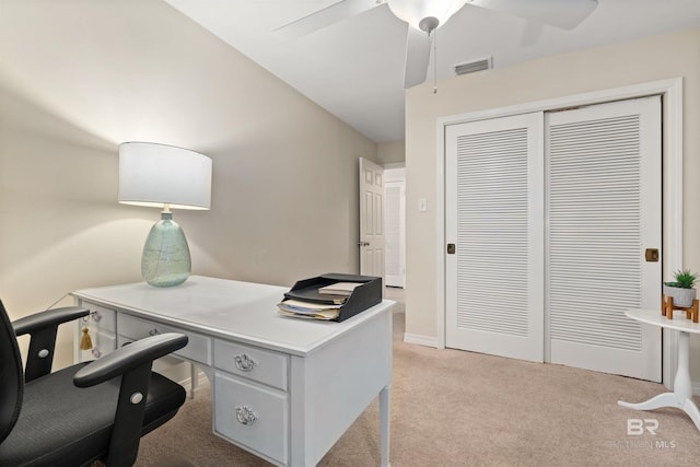 office space with light colored carpet and ceiling fan