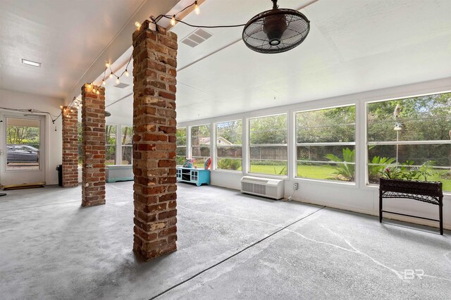 unfurnished sunroom featuring ornate columns