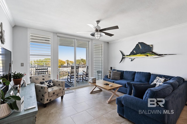 living room featuring tile flooring, ceiling fan, crown molding, and a textured ceiling