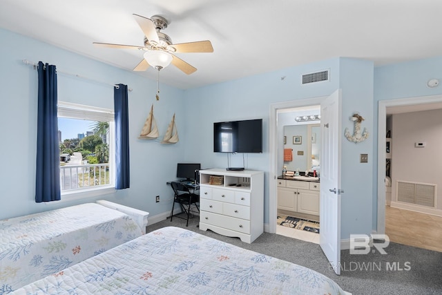 carpeted bedroom featuring sink, ceiling fan, and ensuite bath