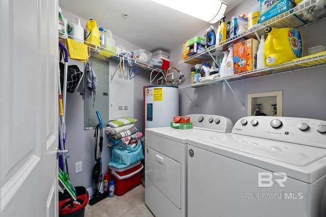 laundry room featuring a textured ceiling, electric water heater, light tile flooring, hookup for a washing machine, and separate washer and dryer