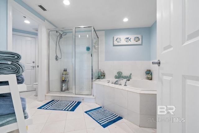 bathroom featuring tile floors and separate shower and tub