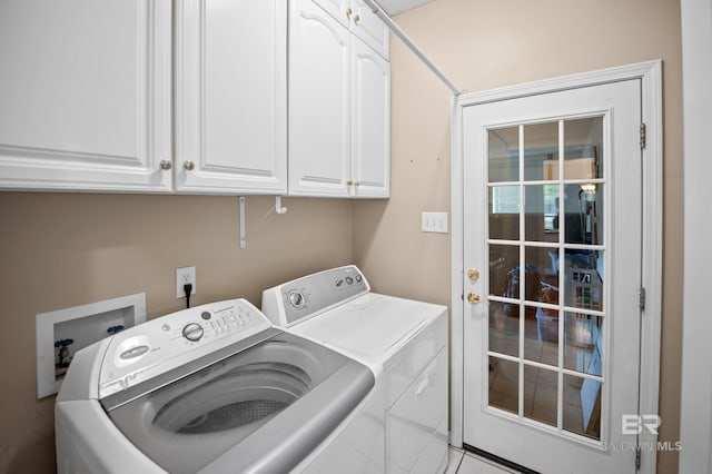washroom with washing machine and dryer and cabinet space