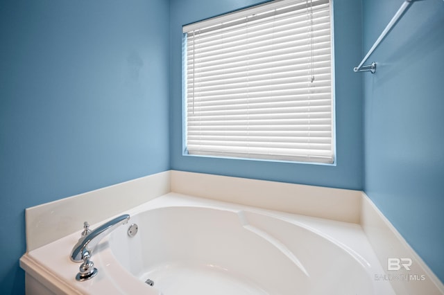 bathroom featuring a bath and a wealth of natural light