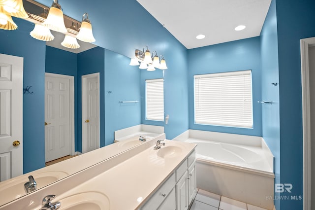 full bathroom featuring a sink, tile patterned flooring, a garden tub, and double vanity