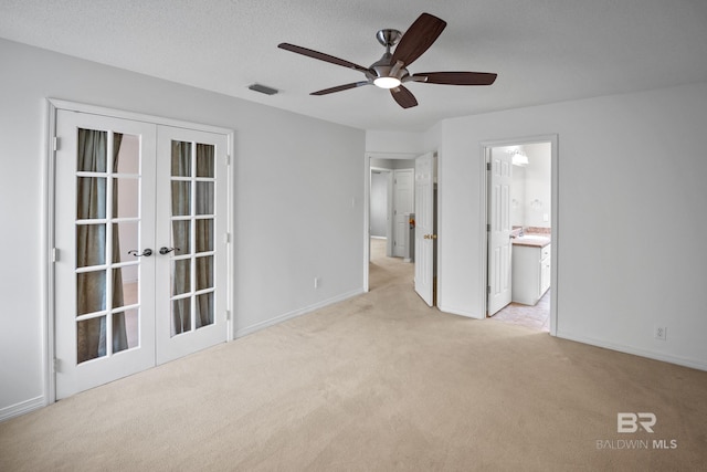 unfurnished bedroom with visible vents, baseboards, french doors, a sink, and carpet
