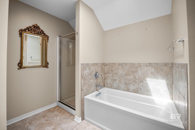 bathroom featuring a garden tub, lofted ceiling, baseboards, tile patterned floors, and a stall shower