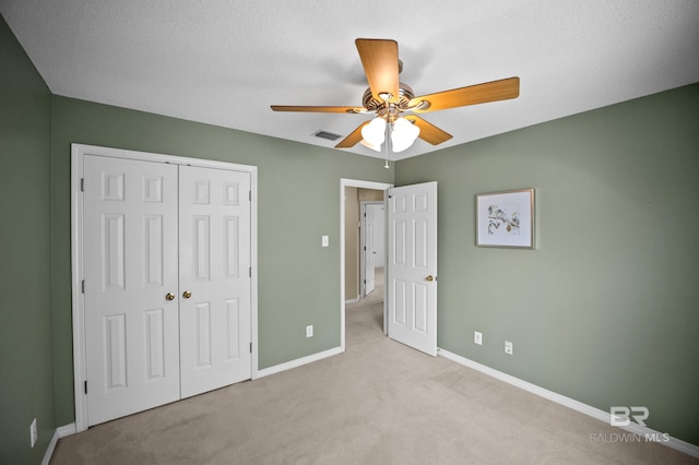 unfurnished bedroom with carpet floors, a ceiling fan, baseboards, visible vents, and a closet