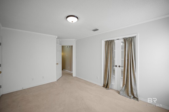 unfurnished bedroom featuring light carpet, french doors, baseboards, visible vents, and ornamental molding