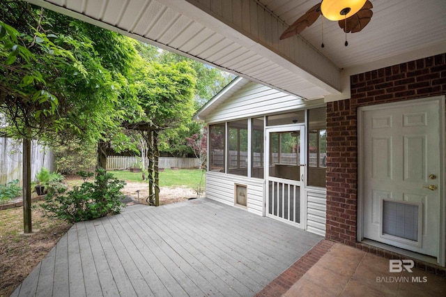 wooden deck with fence, a ceiling fan, and a sunroom
