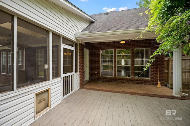 wooden deck with a sunroom
