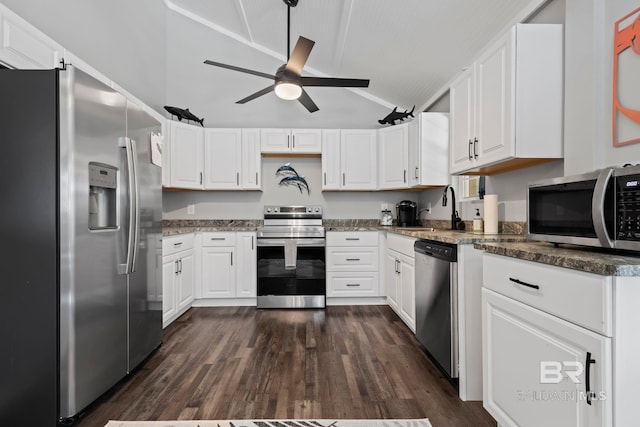 kitchen featuring sink, vaulted ceiling, white cabinets, and appliances with stainless steel finishes