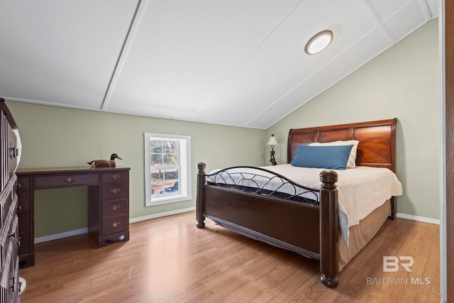 bedroom featuring vaulted ceiling and light wood-type flooring