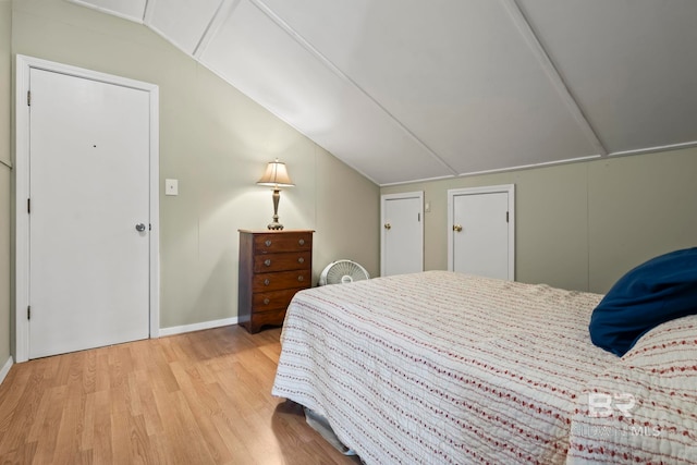 bedroom featuring lofted ceiling and light hardwood / wood-style floors