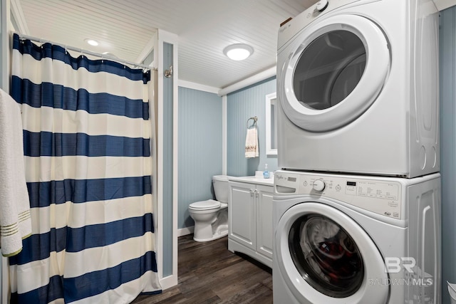 clothes washing area featuring stacked washer and clothes dryer and dark hardwood / wood-style floors