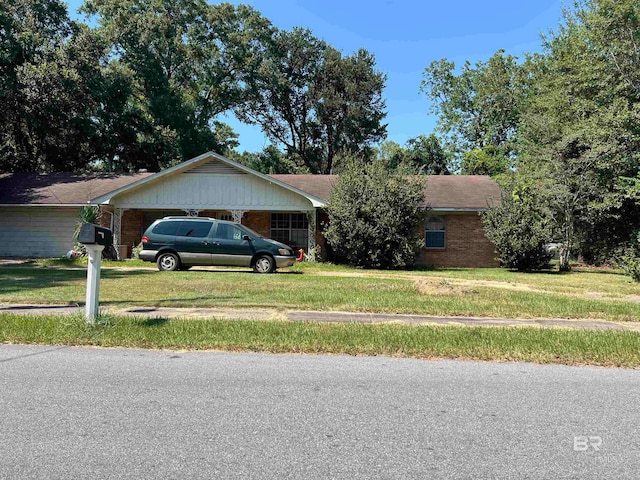 ranch-style house featuring a garage and a front yard