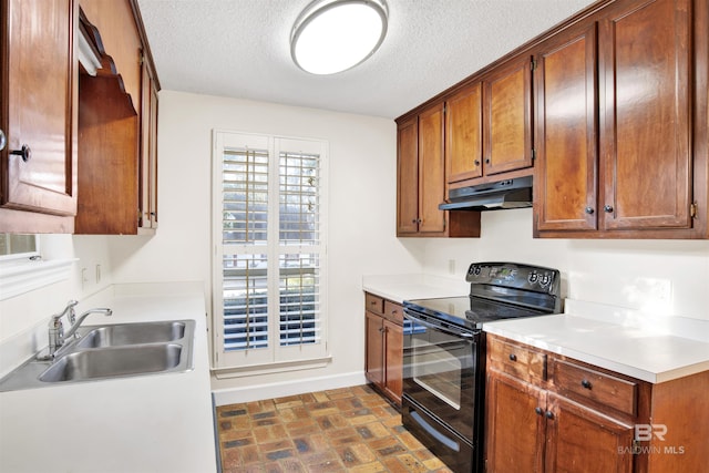 kitchen featuring black electric range, a textured ceiling, and sink