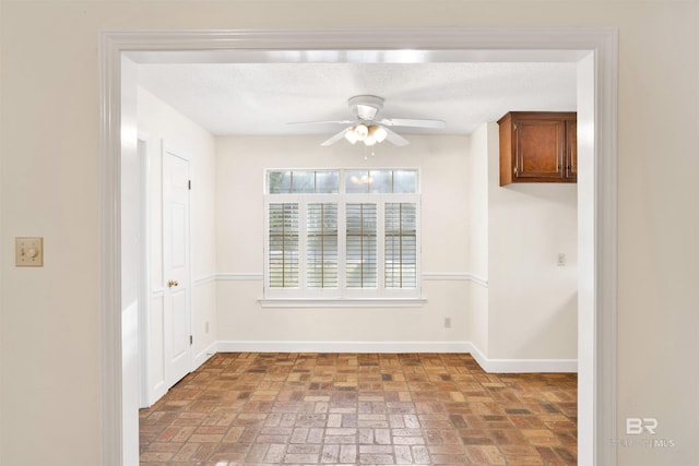 unfurnished dining area with ceiling fan