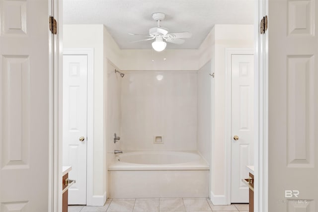 bathroom featuring tile patterned flooring, ceiling fan, tub / shower combination, and a textured ceiling