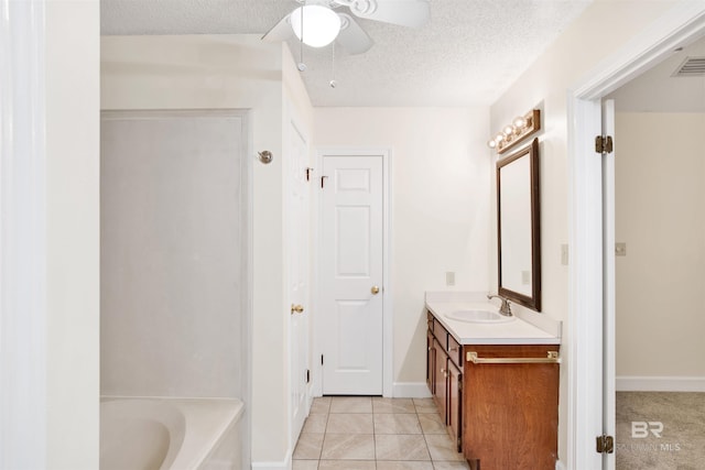 bathroom featuring a textured ceiling, vanity, tile patterned floors, and ceiling fan