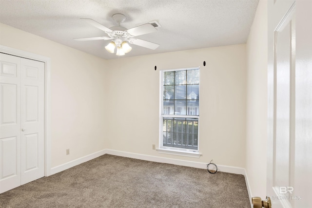 unfurnished bedroom featuring a textured ceiling, carpet floors, a closet, and ceiling fan