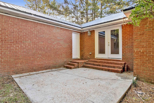 property entrance featuring a patio area and french doors