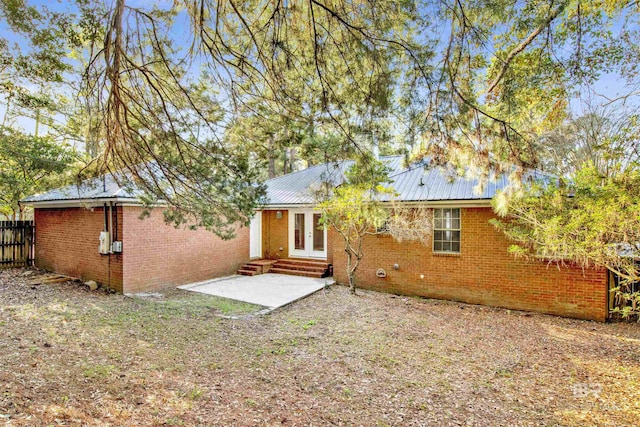 rear view of house with a patio area and french doors