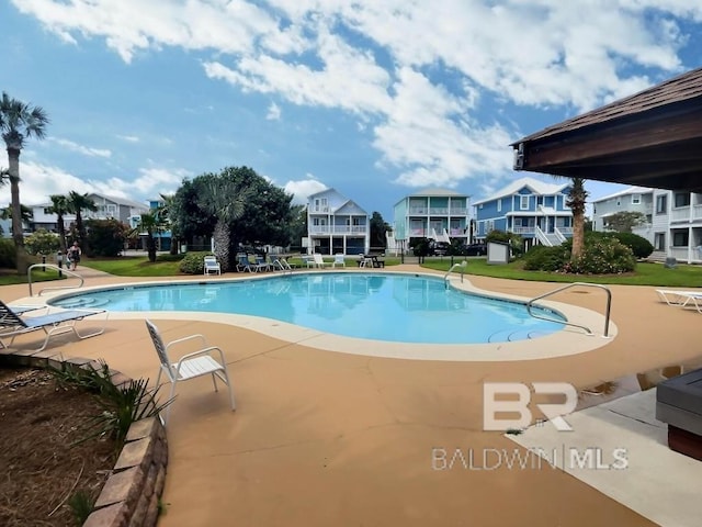 view of pool featuring a patio area and a lawn