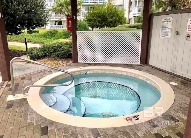 view of swimming pool featuring a community hot tub